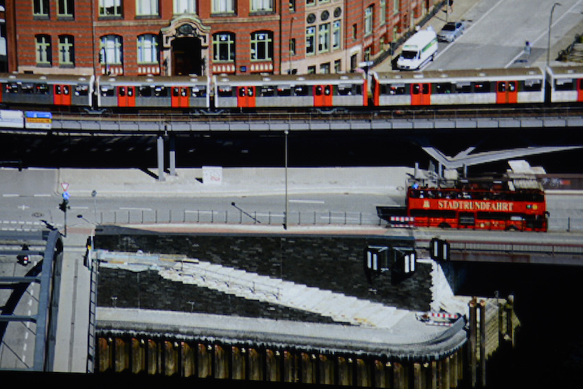 Die Ausschnittsvergrößerung des Hamburg-Panoramas zeigt deutlich auf, dass der BenQ W1350 eine gute Pixelauflösung besitzt. Vollkommen verfärbungsfrei erscheinen die graue Straße, die orangefarbenen Türen der U-Bahn und der rote Doppeldecker. Originalaufnahme/Foto: Michael B. Rehders