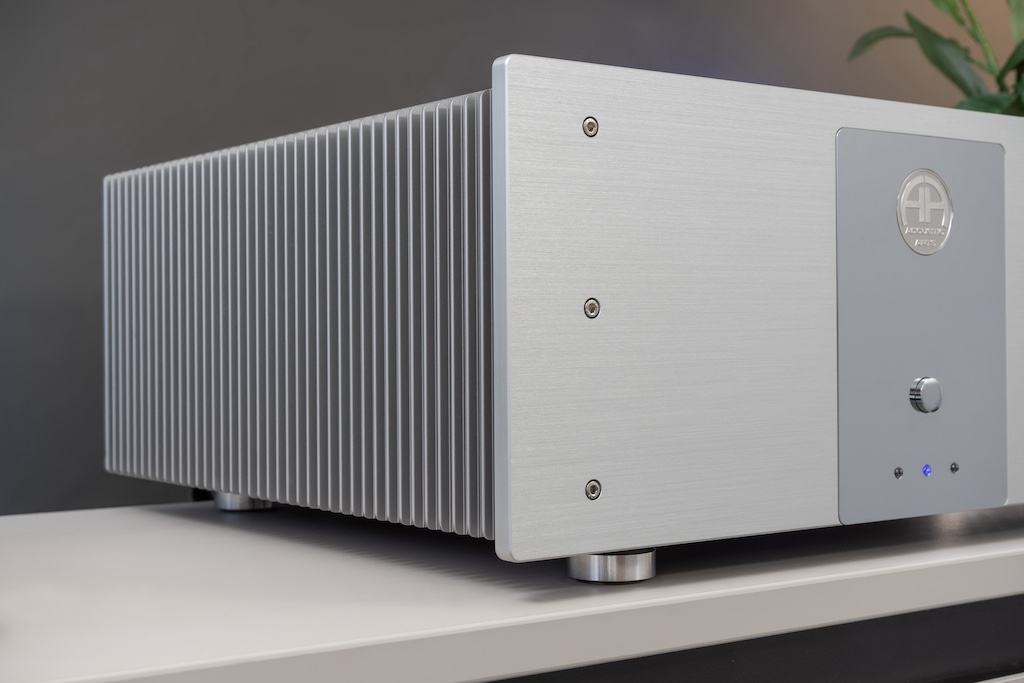 Die Wangen des Amp I sind komplett als Kühlkörper ausgelegt. Die aus dem Vollen gefrästen Rippen-Areale bietet eine große Abstrahlfläche und sorgen so für eine effektive Abfuhr der Wärme: Die Leistungstransistoren des Verstärkers haben über eine massive innseitige Metallplatte unmittelbaren thermischen Kontakt mit den Kühlkörpern. Die elegant abgerundeten Lamellen befördern die optische Leichtigkeit und Eleganz des Verstärkers – wie auch die feine Fasung aller Kanten. Die Front beeindruckt wie immer bei Accustic Arts mit dem Strichbild des gebürsteten Aluminiums und dem sanften Schimmer der veredelten Oberfläche.
